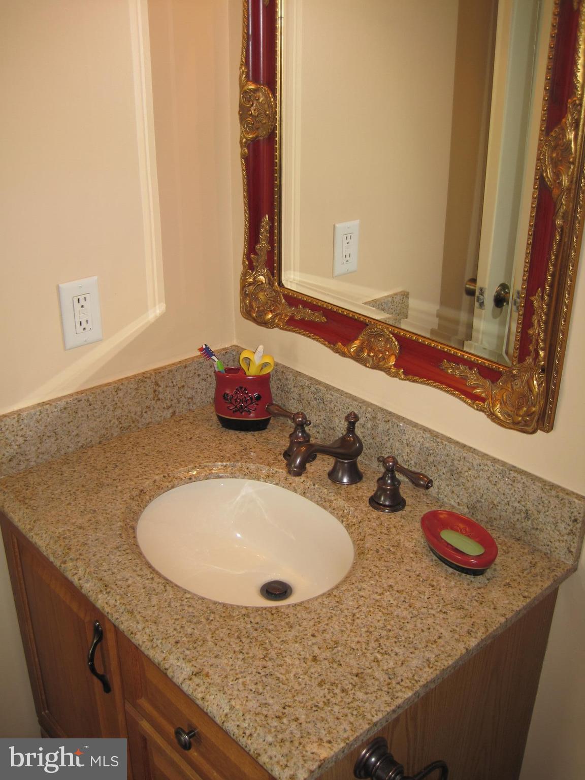 6178 Morning Glory Road Alexandria, VA 22310 - Photo 19 of 26 a bathroom with a granite countertop sink and a mirror