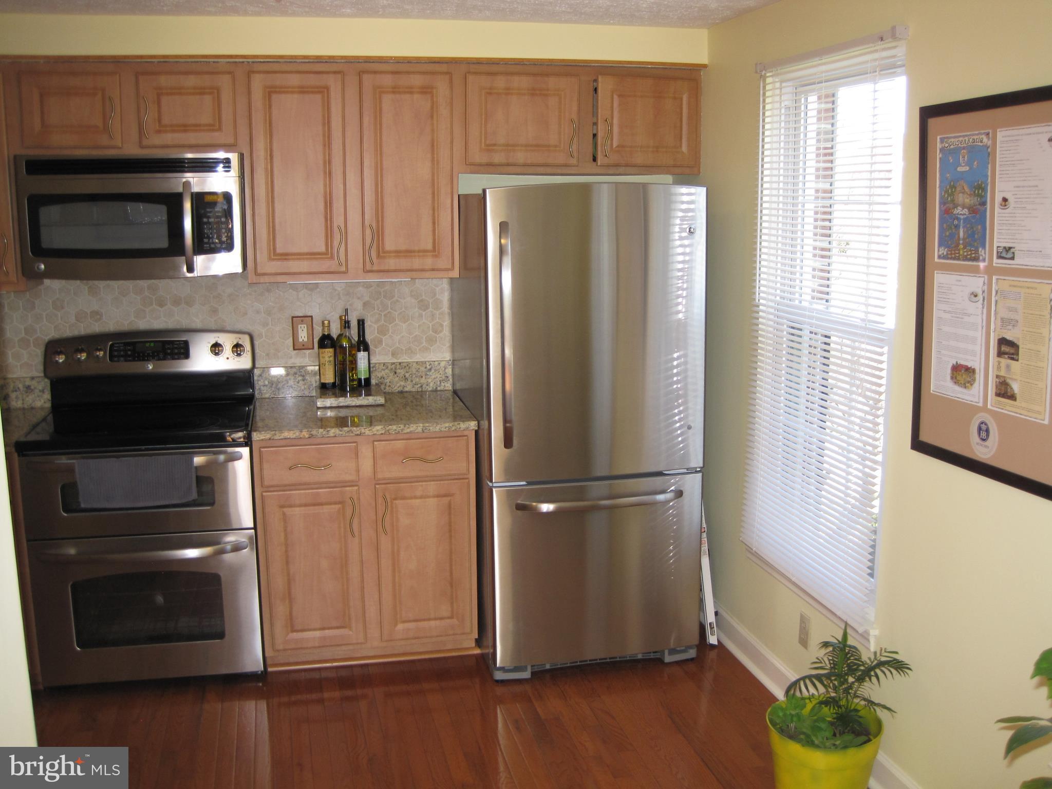 6178 Morning Glory Road Alexandria, VA 22310 - Photo 4 of 26 a kitchen with a refrigerator stove and microwave