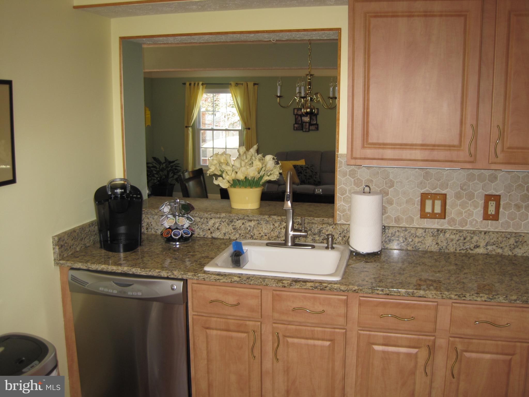 6178 Morning Glory Road Alexandria, VA 22310 - Photo 7 of 26 a kitchen with sink a stove and cabinets