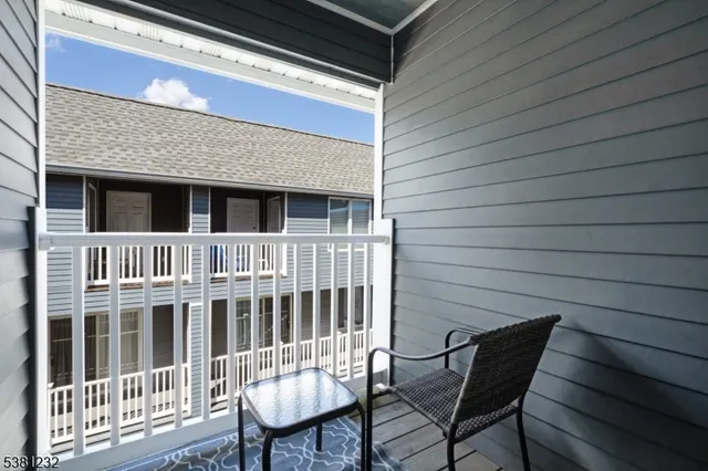 a view of a chair and table in the roof deck