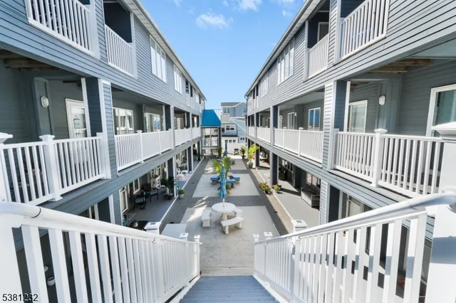 a view of balcony with wooden floor and wooden fence