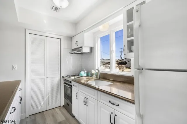 a bathroom with a sink a mirror and a shower