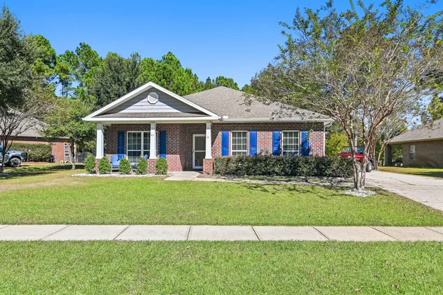 a front view of a house with a yard table and chairs