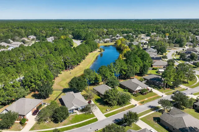 an aerial view of residential houses with outdoor space and street view