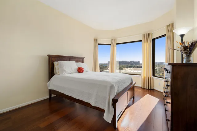 a bedroom with a bed and a large window