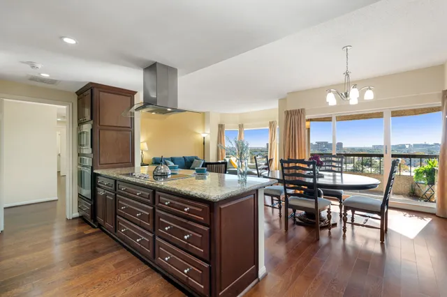 a kitchen with a stove a table and chairs in it