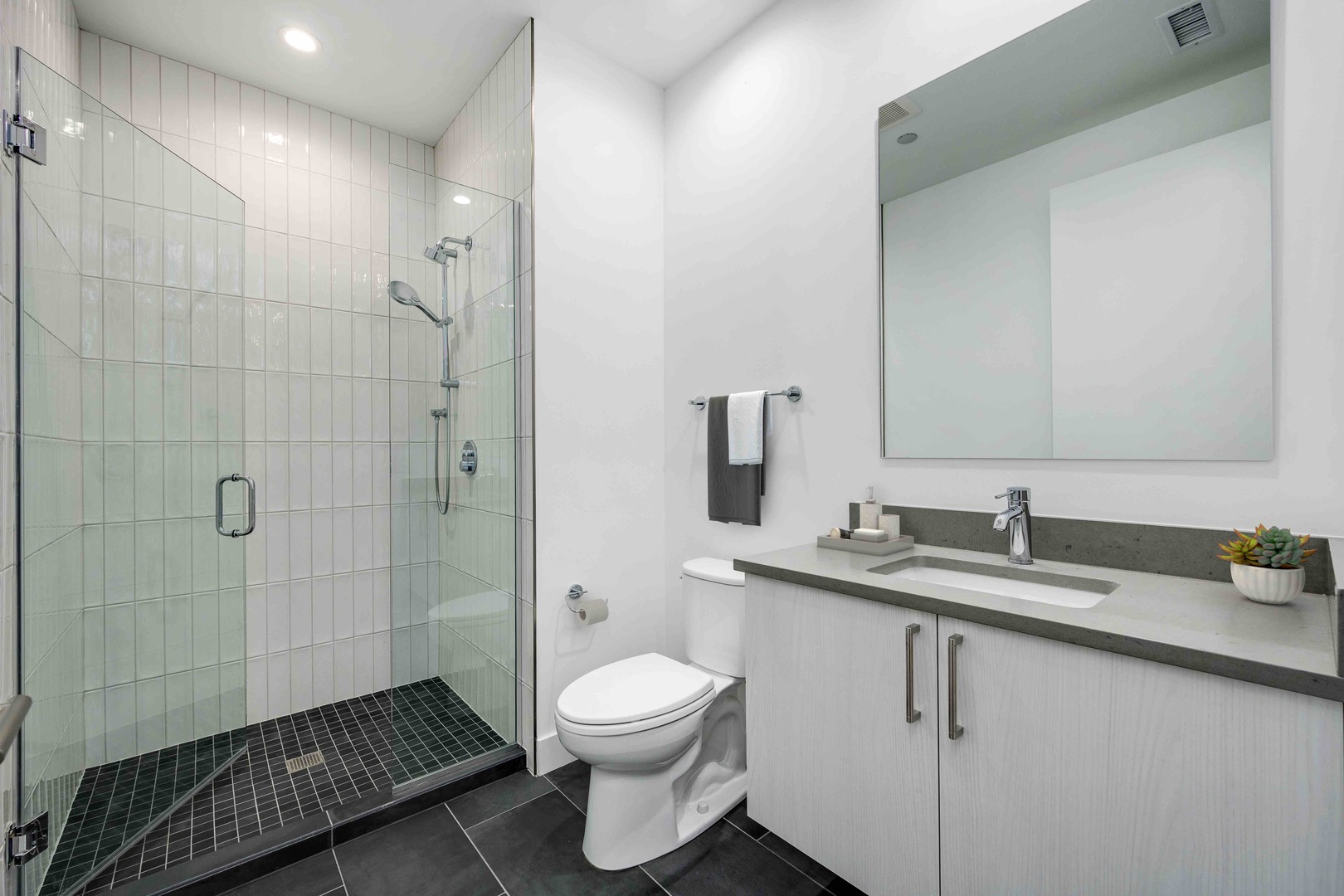 313 South Racine Avenue, Unit PHB Chicago, IL 60607 - Photo 16 of 30 a bathroom with a granite countertop sink toilet a mirror and shower