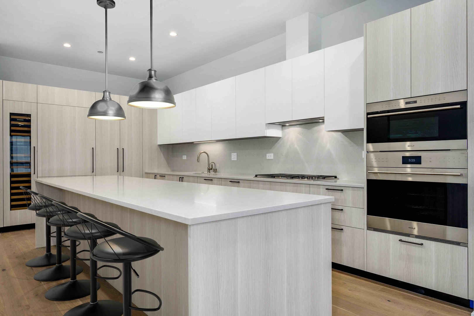 313 South Racine Avenue, Unit PHB Chicago, IL 60607 - Photo 9 of 30 a kitchen with stainless steel appliances a sink a stove a microwave a center island and cabinets