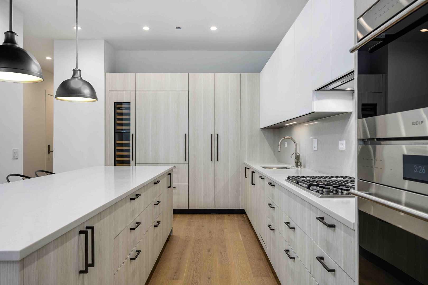 313 South Racine Avenue, Unit PHB Chicago, IL 60607 - Photo 10 of 30 a kitchen with stainless steel appliances a refrigerator a sink and wooden cabinets