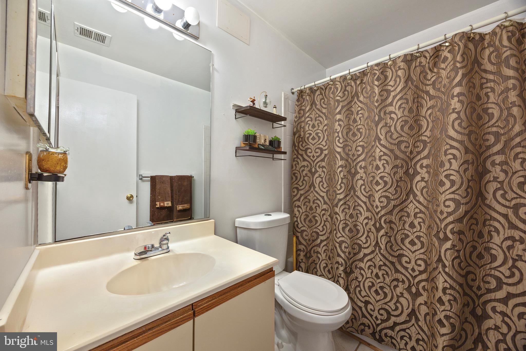 14106 William Street, Unit 19B Laurel, MD 20707 - Photo 16 of 31 a bathroom with a sink toilet and a mirror