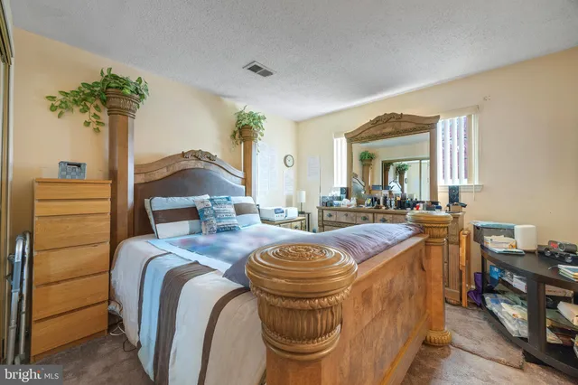 a bed room with a bed and a potted plant