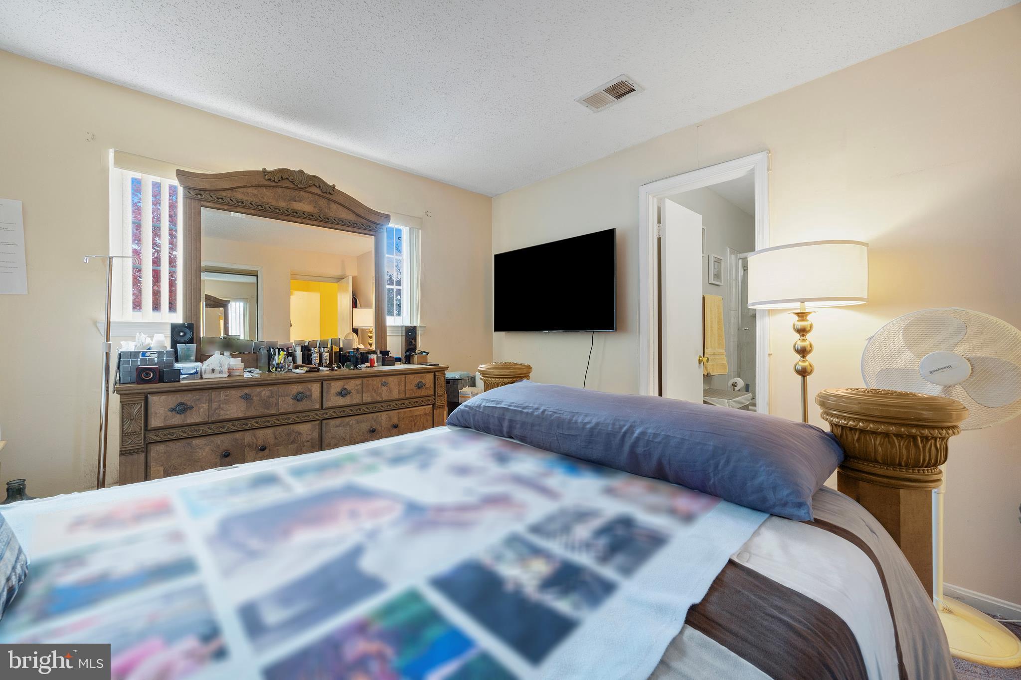 14106 William Street, Unit 19B Laurel, MD 20707 - Photo 18 of 31 a bedroom with a bed and a flat screen television