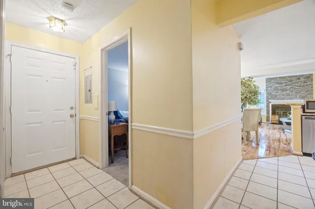 a bedroom with a bed and a flat tv screen on the dresser
