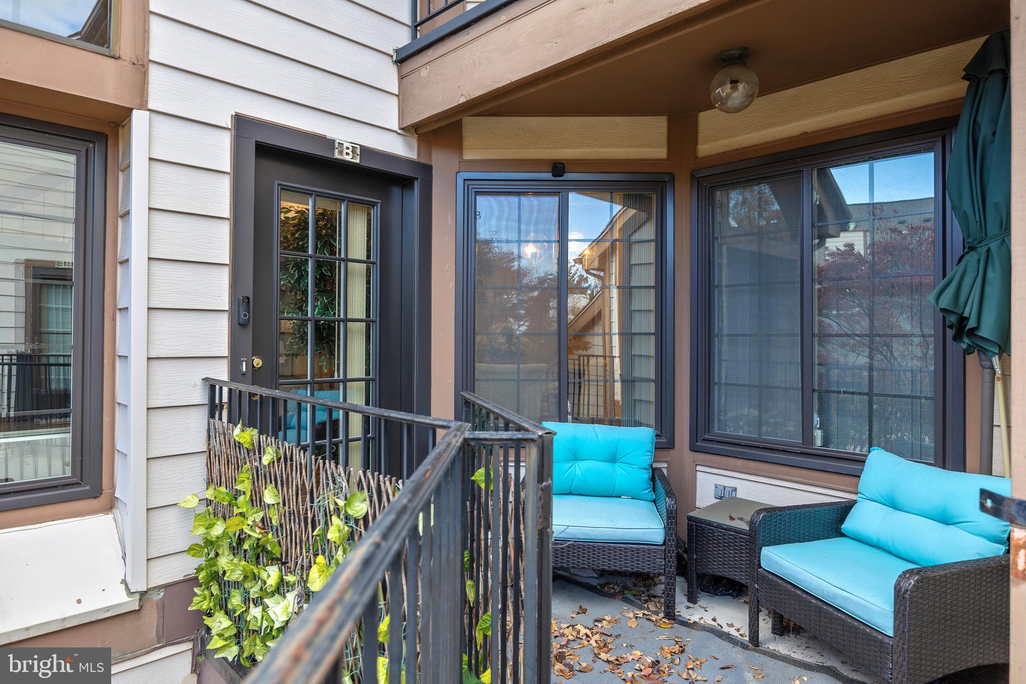 14106 William Street, Unit 19B Laurel, MD 20707 - Photo 3 of 31 a balcony with furniture and a potted plant