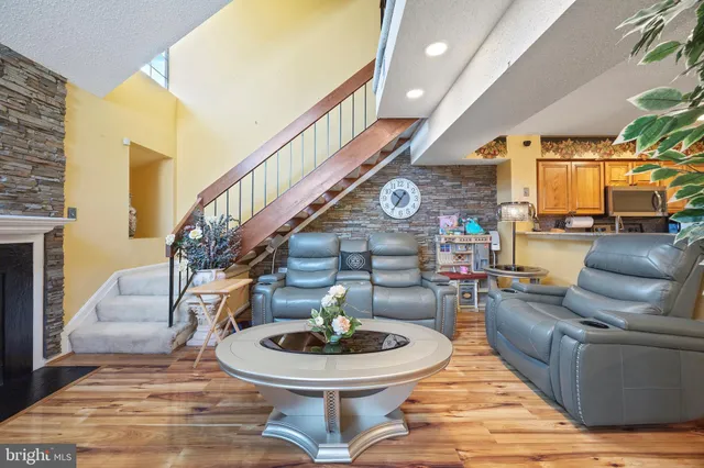 a living room with couches chairs and a dining table with garden view