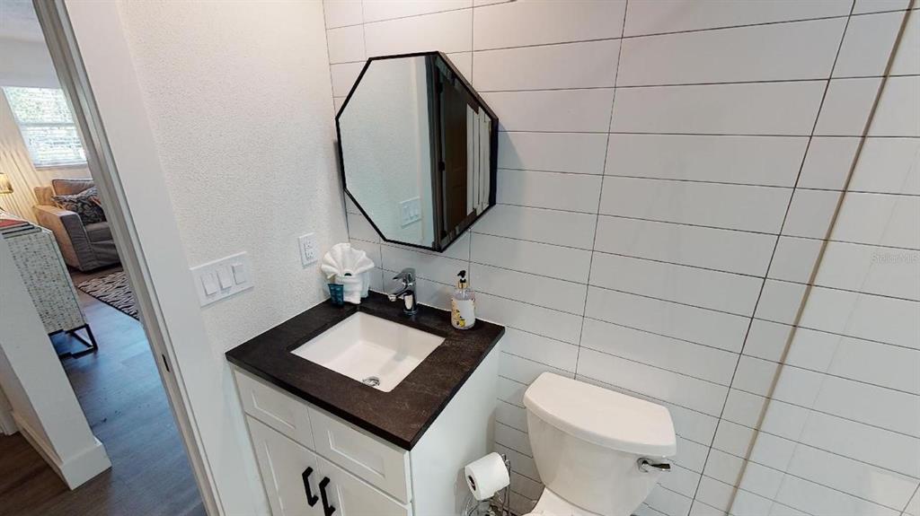 1910 Morrill Street Sarasota, FL 34236 - Photo 23 of 52 a bathroom with a toilet a sink and a mirror