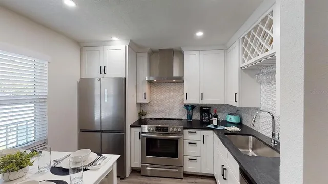 a large bed sitting in a bedroom next to a window