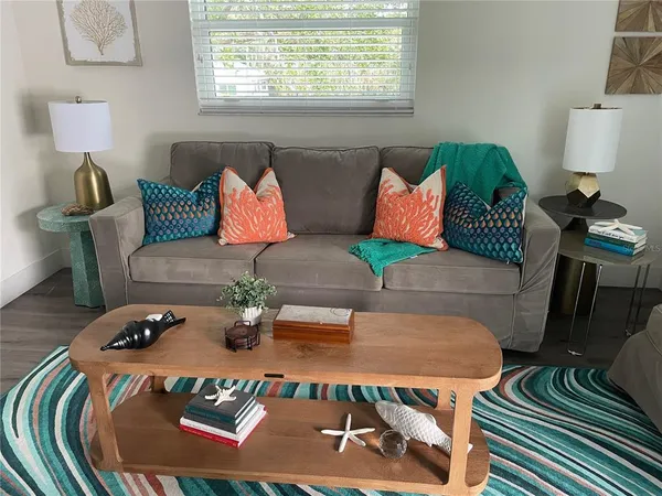 a living room with furniture and a lamp