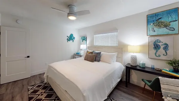 a kitchen with stainless steel appliances granite countertop a refrigerator a sink dishwasher a dining table and chairs with wooden floor