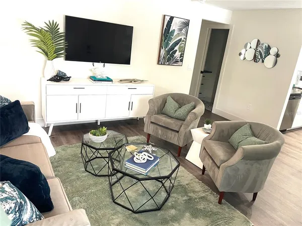 a living room with furniture and a flat screen tv
