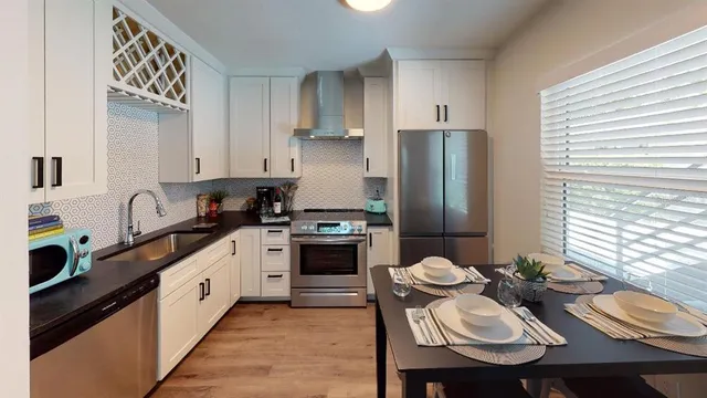a view of a livingroom with furniture and a window