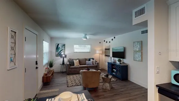 a kitchen with a stove and a wooden floor