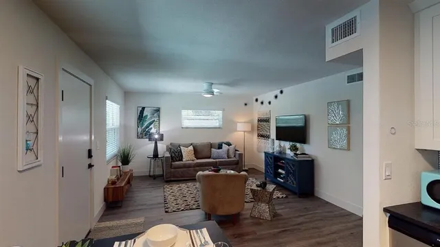 a kitchen with a stove and a wooden floor