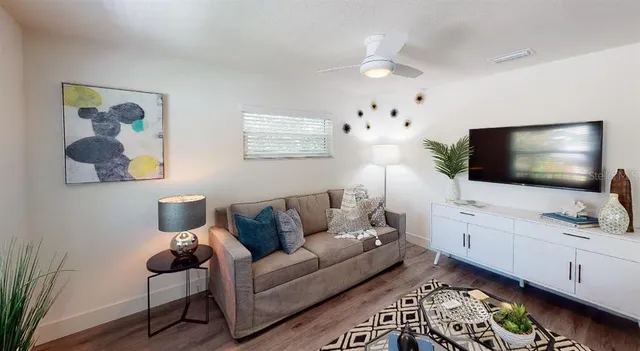 a bedroom with a bed and a television