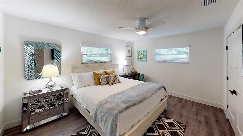 1910 Morrill Street Sarasota, FL 34236 - Photo 51 of 52 a bedroom with a bed and a lamp on the dresser