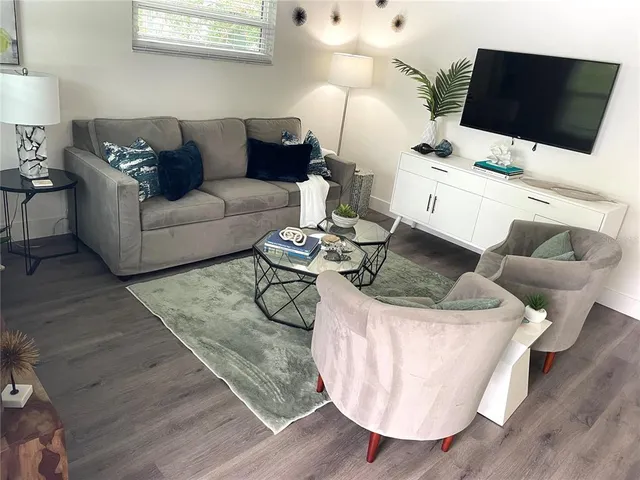 a living room with furniture and a flat screen tv