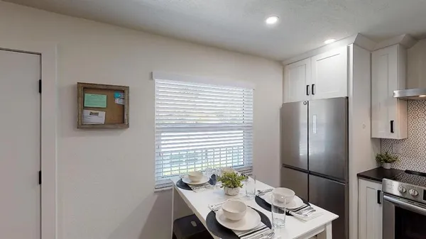 a kitchen with a refrigerator and a table