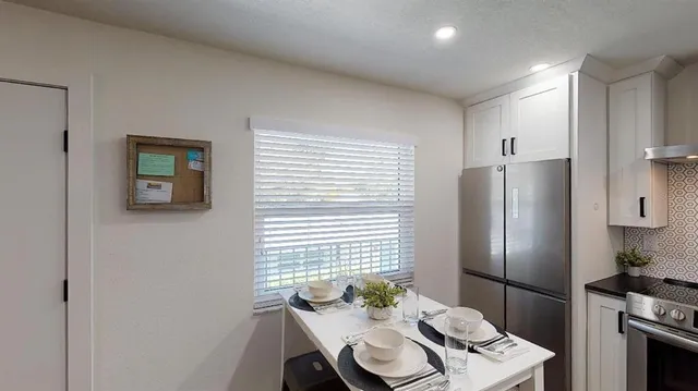 a kitchen with a refrigerator and a table