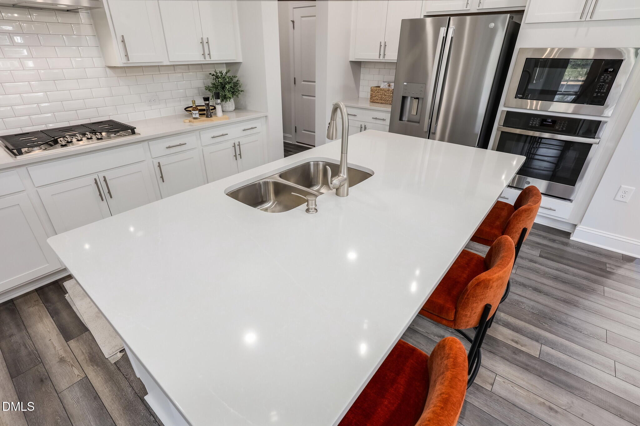 112 Fablewood Trail Garner, NC 27529 - Photo 12 of 39 a kitchen with stainless steel appliances a stove a sink a microwave and a refrigerator