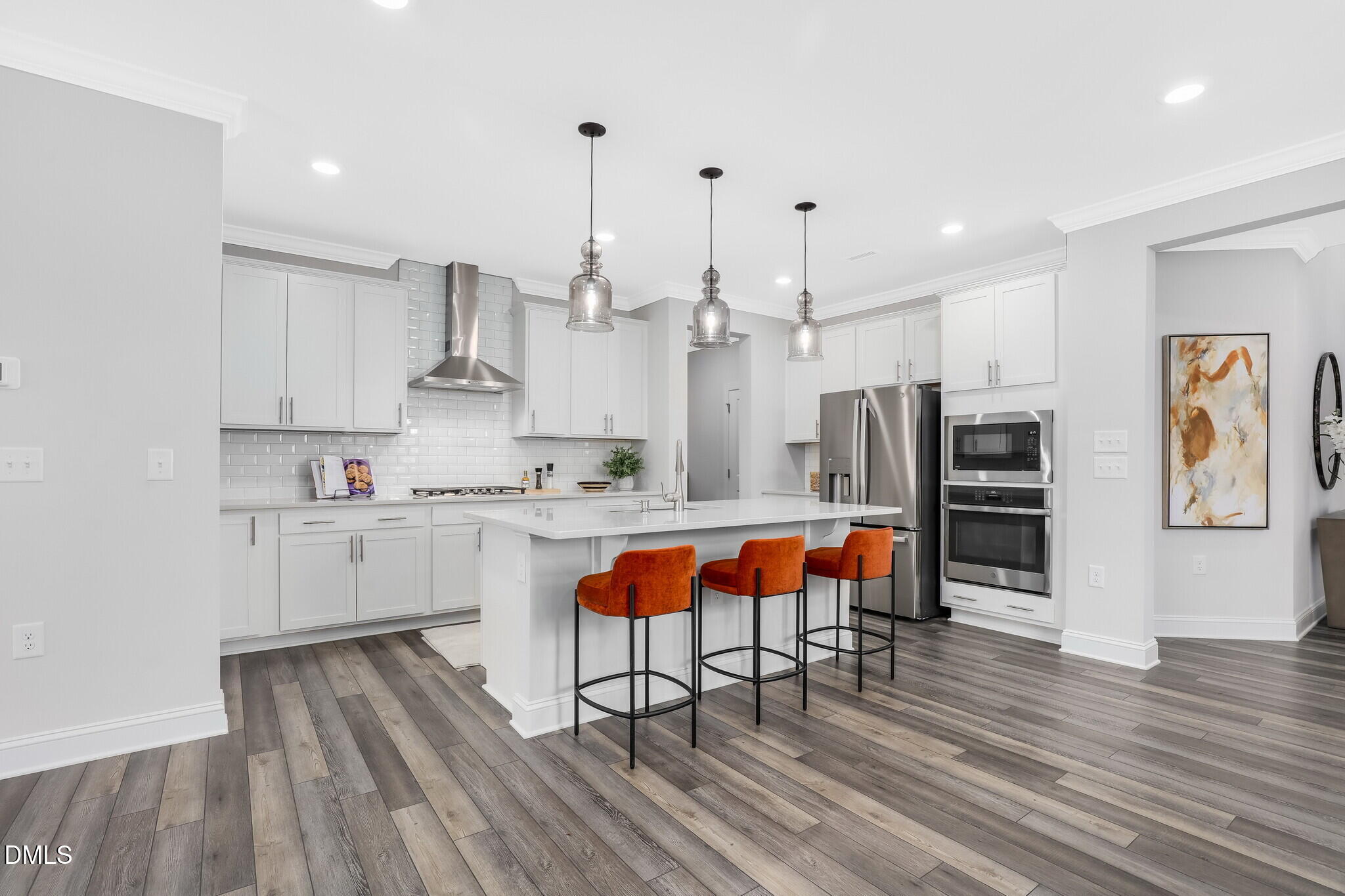112 Fablewood Trail Garner, NC 27529 - Photo 5 of 39 a kitchen with stainless steel appliances granite countertop a refrigerator a oven a stove and white cabinets with wooden floor
