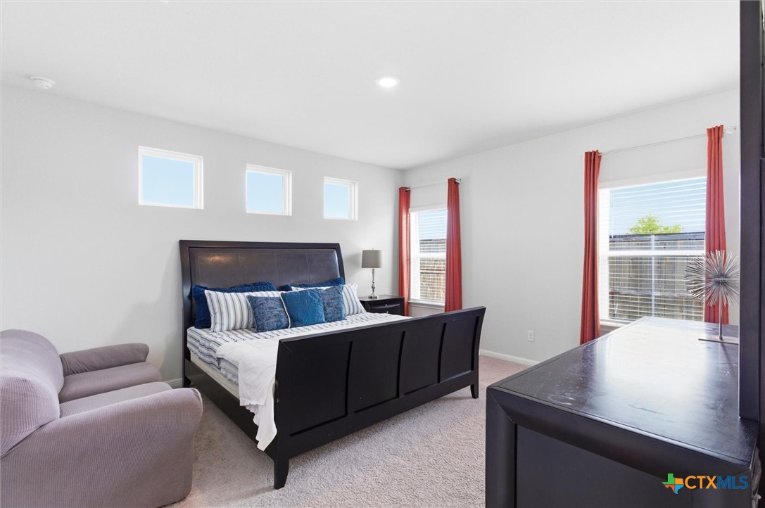 149 Cutleaf, Unit 31 San Marcos, TX 78666 - Photo 11 of 26 a bedroom with furniture and a window