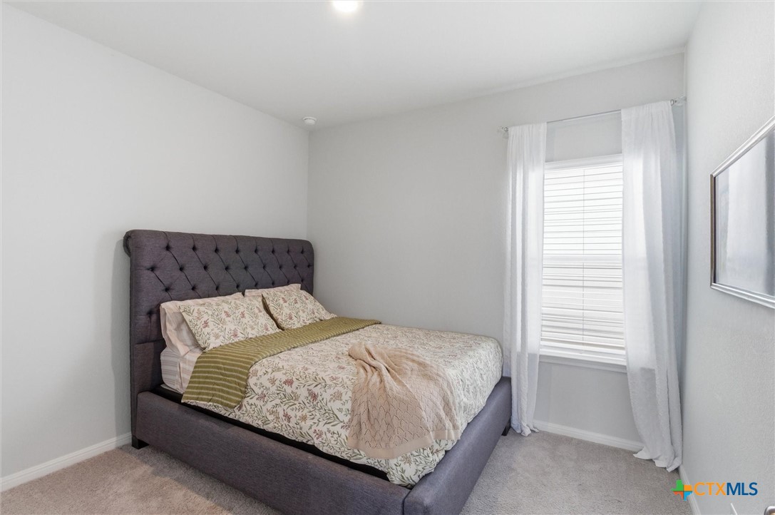 149 Cutleaf, Unit 31 San Marcos, TX 78666 - Photo 14 of 26 a bedroom with a bed and window