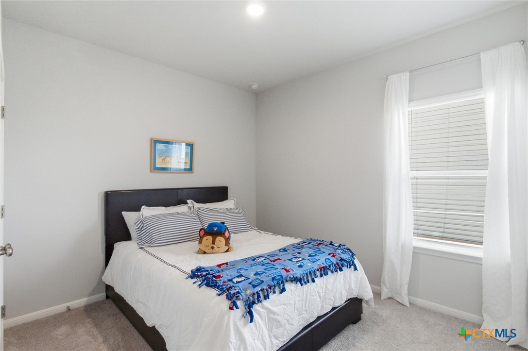 149 Cutleaf, Unit 31 San Marcos, TX 78666 - Photo 15 of 26 a bedroom with a bed and a window