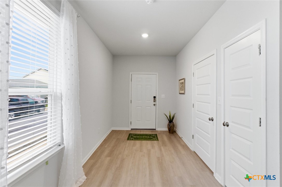 149 Cutleaf, Unit 31 San Marcos, TX 78666 - Photo 4 of 26 a view of a room with wooden floor and a bathroom