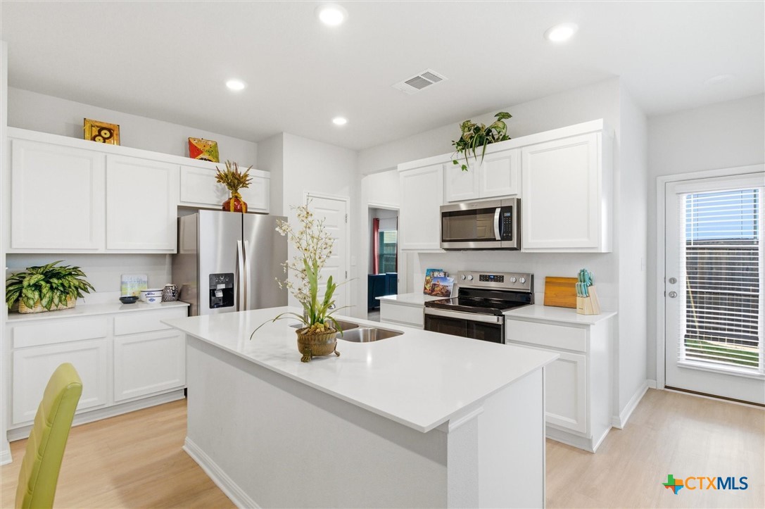 149 Cutleaf, Unit 31 San Marcos, TX 78666 - Photo 10 of 26 a kitchen with stainless steel appliances a stove refrigerator sink and microwave