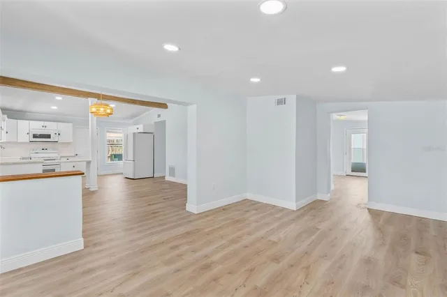 a kitchen with stainless steel appliances granite countertop a sink a window and a white counter