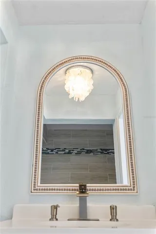 a view of a room with wooden floor and a bathroom