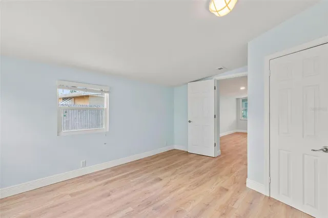 a vase of flowers sitting on a sidewalk