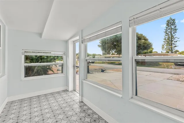 a living room with furniture a fireplace and a large window