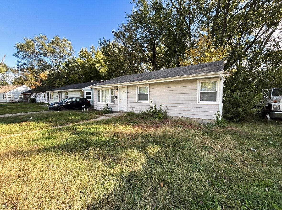 a view of a house with pool and sitting area