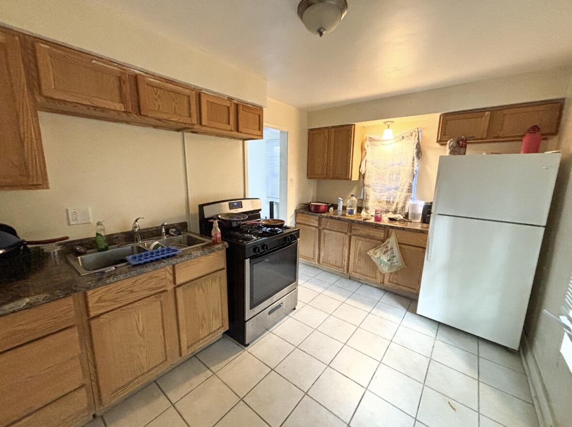 1163 Allen Street Gary, IN 46403 - Photo 8 of 13 a kitchen with stainless steel appliances granite countertop a sink stove and refrigerator