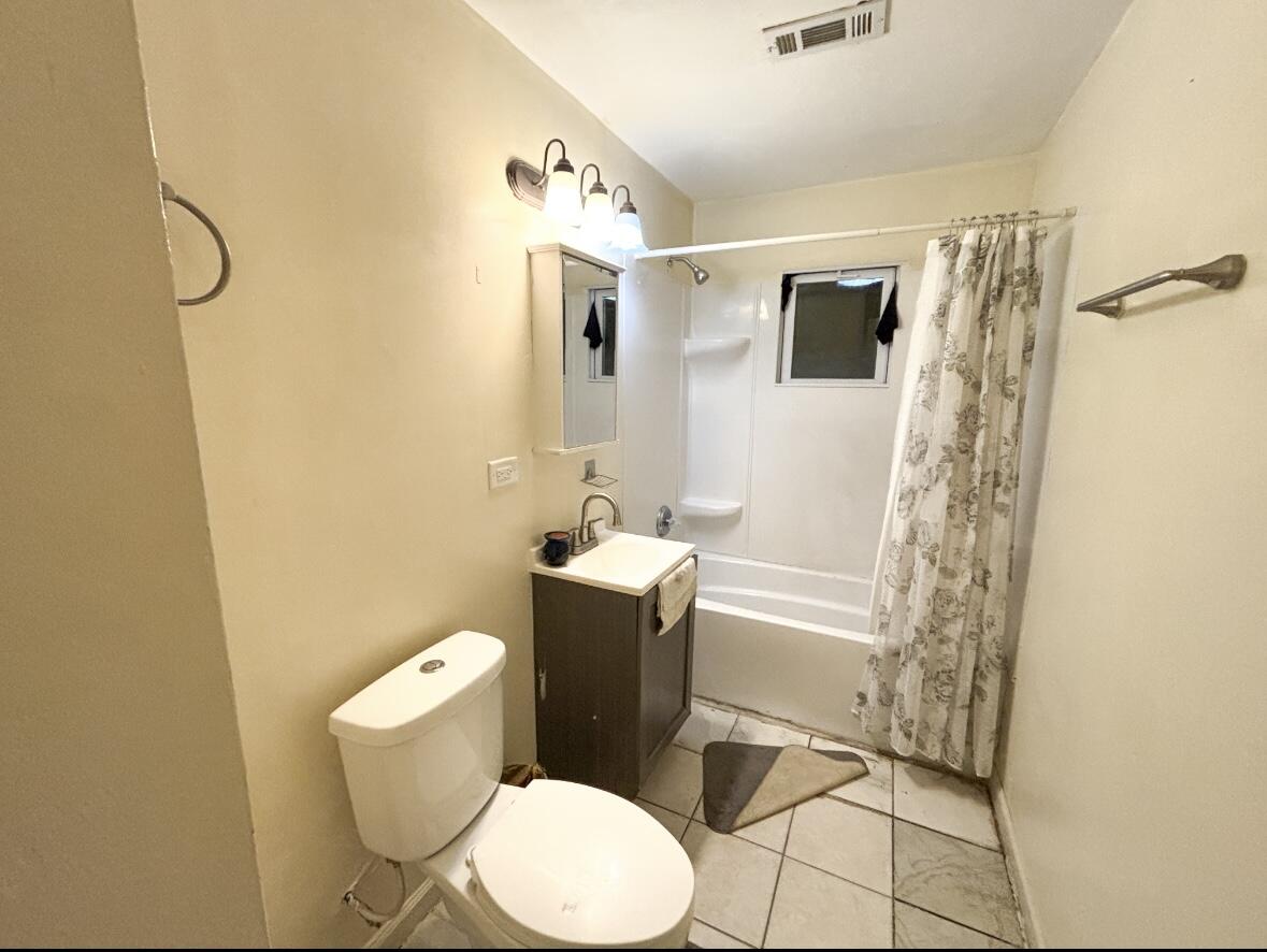 1163 Allen Street Gary, IN 46403 - Photo 9 of 13 a white toilet sitting next to a bathroom sink