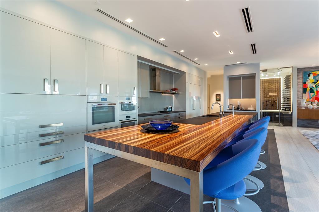2300 Wolf Street, Unit 18A Dallas, TX 75201 - Photo 15 of 40 a room with table chairs and wooden floor