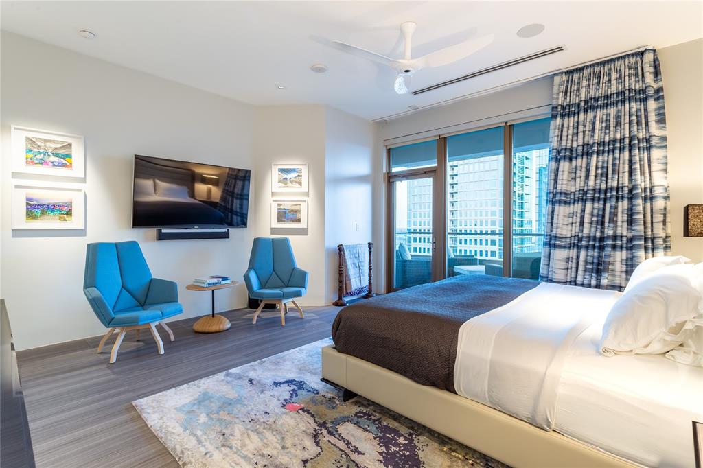 2300 Wolf Street, Unit 18A Dallas, TX 75201 - Photo 21 of 40 a bedroom with a bed a flat screen tv and a large window