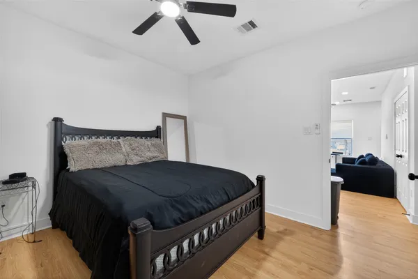 a bedroom with a bed and wooden floor