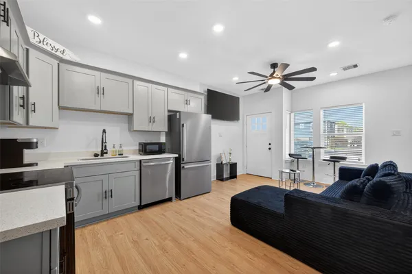 a living room with stainless steel appliances kitchen island granite countertop furniture and a kitchen view